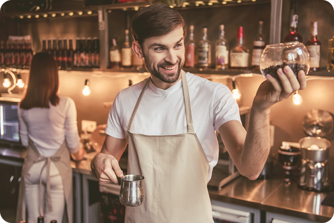Barista holding tray in a cafe environment